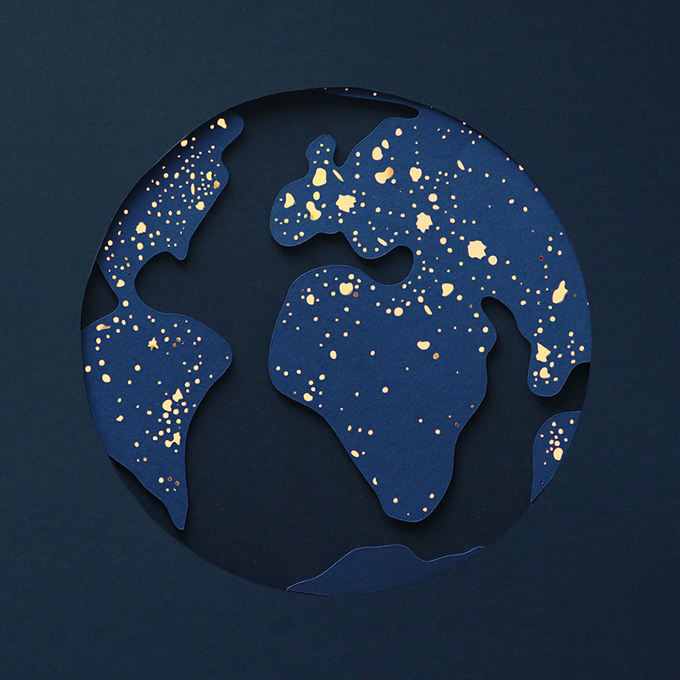 Paper Earth with lit up city lights
