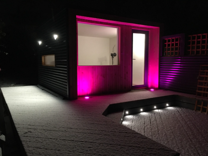 snowy garden studio cabin with pink lights
